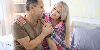 A man and a woman look lovingly at each other