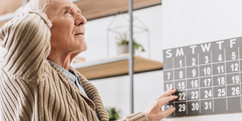 Man with Alzheimer's disease seems confused over the date