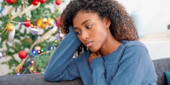 A woman feeling depressed or sad during the holiday season