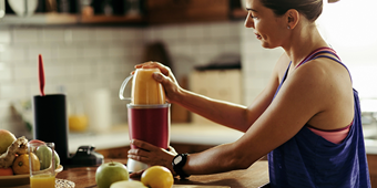 Women juicing fruit and vegetables