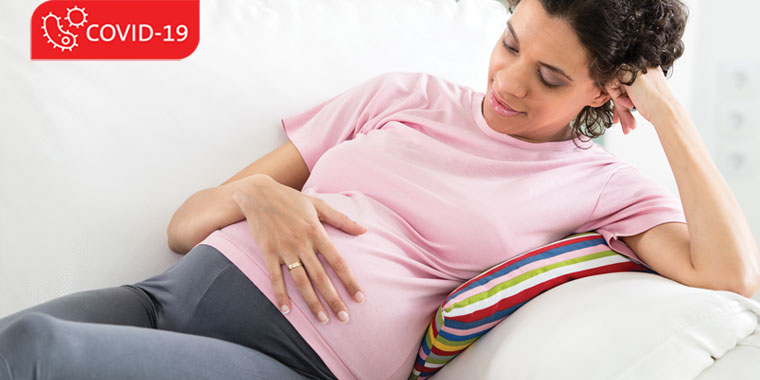 Pregnant woman sitting on a couch
