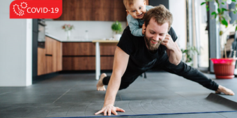 Dad doing physical activity while child is on his back