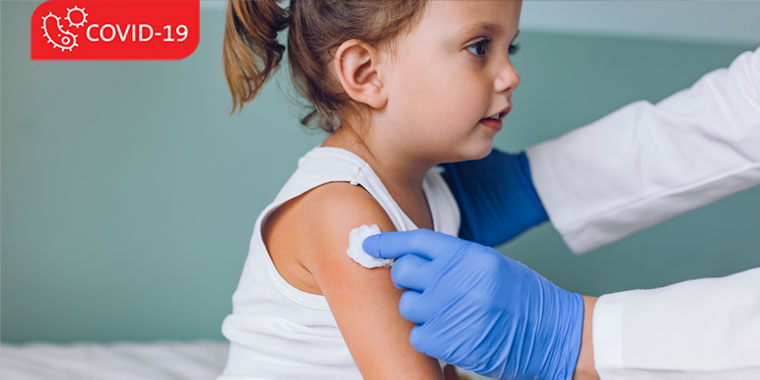 Young child at a doctor's office, preparing for a vaccine. 