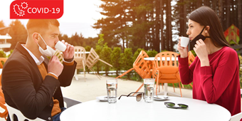 Couple having a social distancing meal at a restaurant